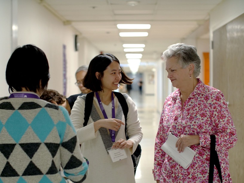 Faculty member and student talking in a hallway