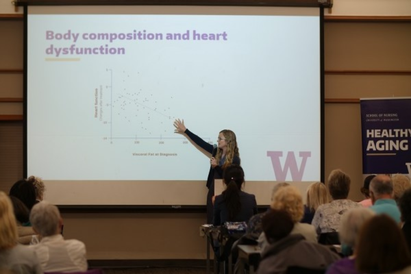 Presenter points to a projected in front of audience