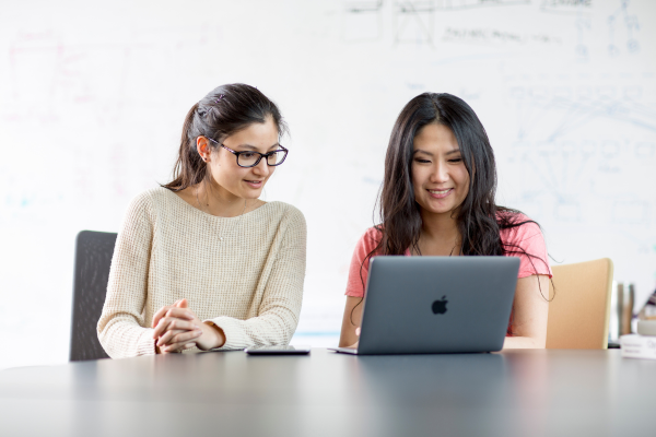 Two people looking at a computer screen